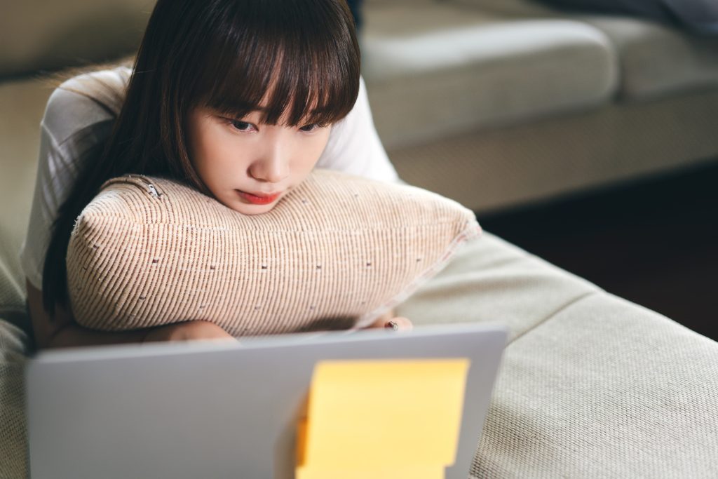 College student attending a counseling session on their laptop.