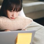 College student attending a counseling session on their laptop.